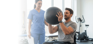 a nurse supervising while a patient does physical therapy exercises.